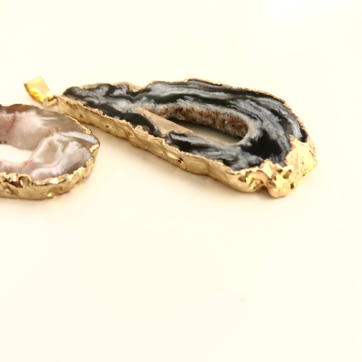 Two Geode Sliced pendants with Gold plated edge