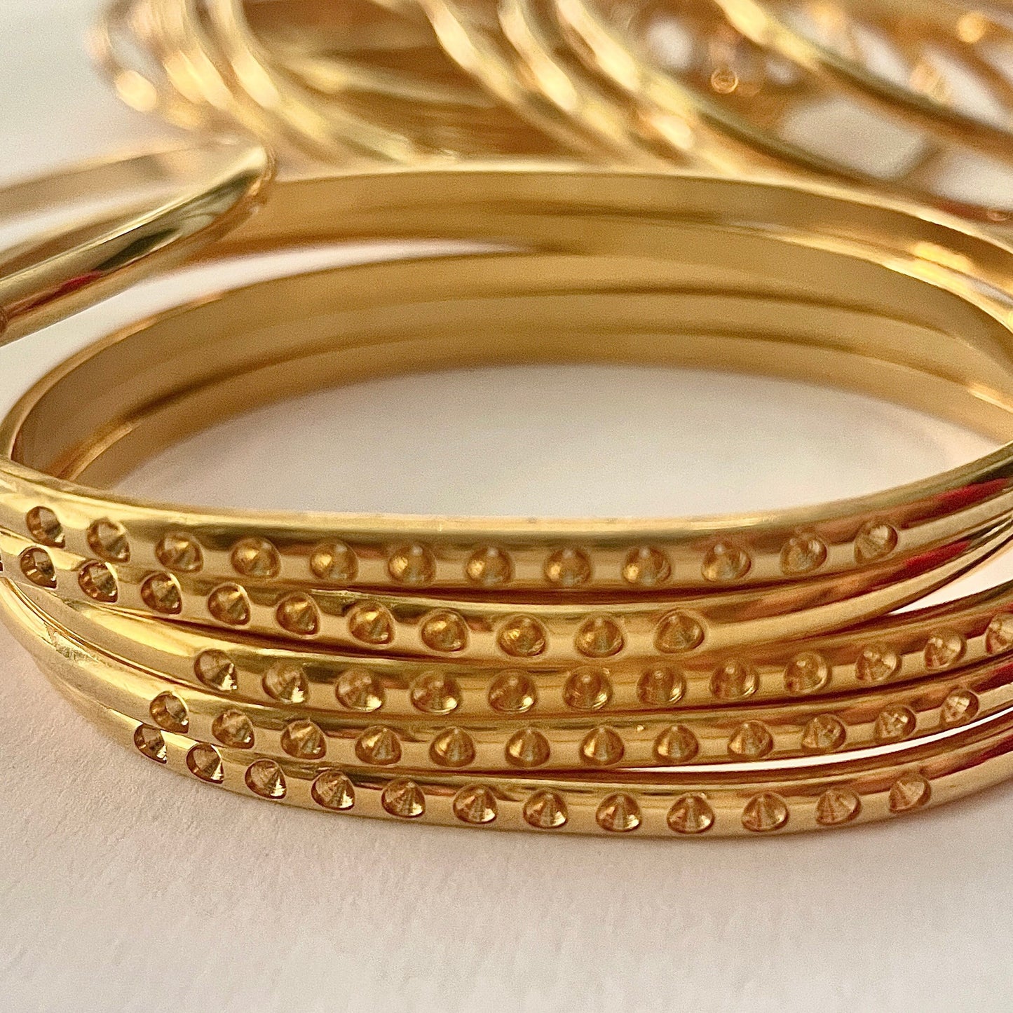 5 Gold Plated 1/8" wide domed bangle is oval shaped w/twelve 13pp cavities