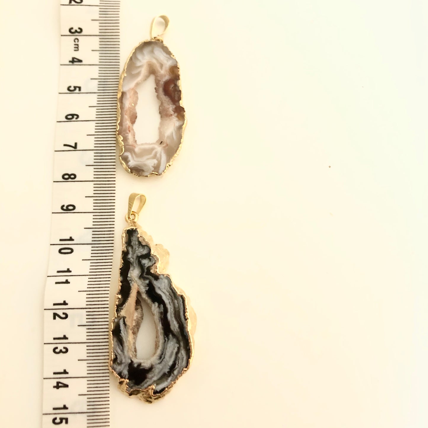 Two Geode Sliced pendants with Gold plated edge